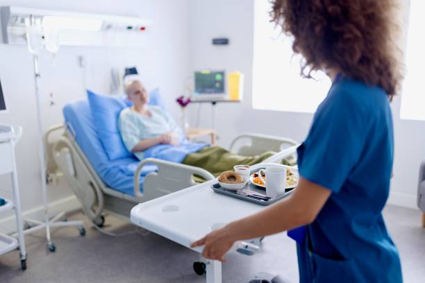 Nurse giving lunch to the patient in the hospital